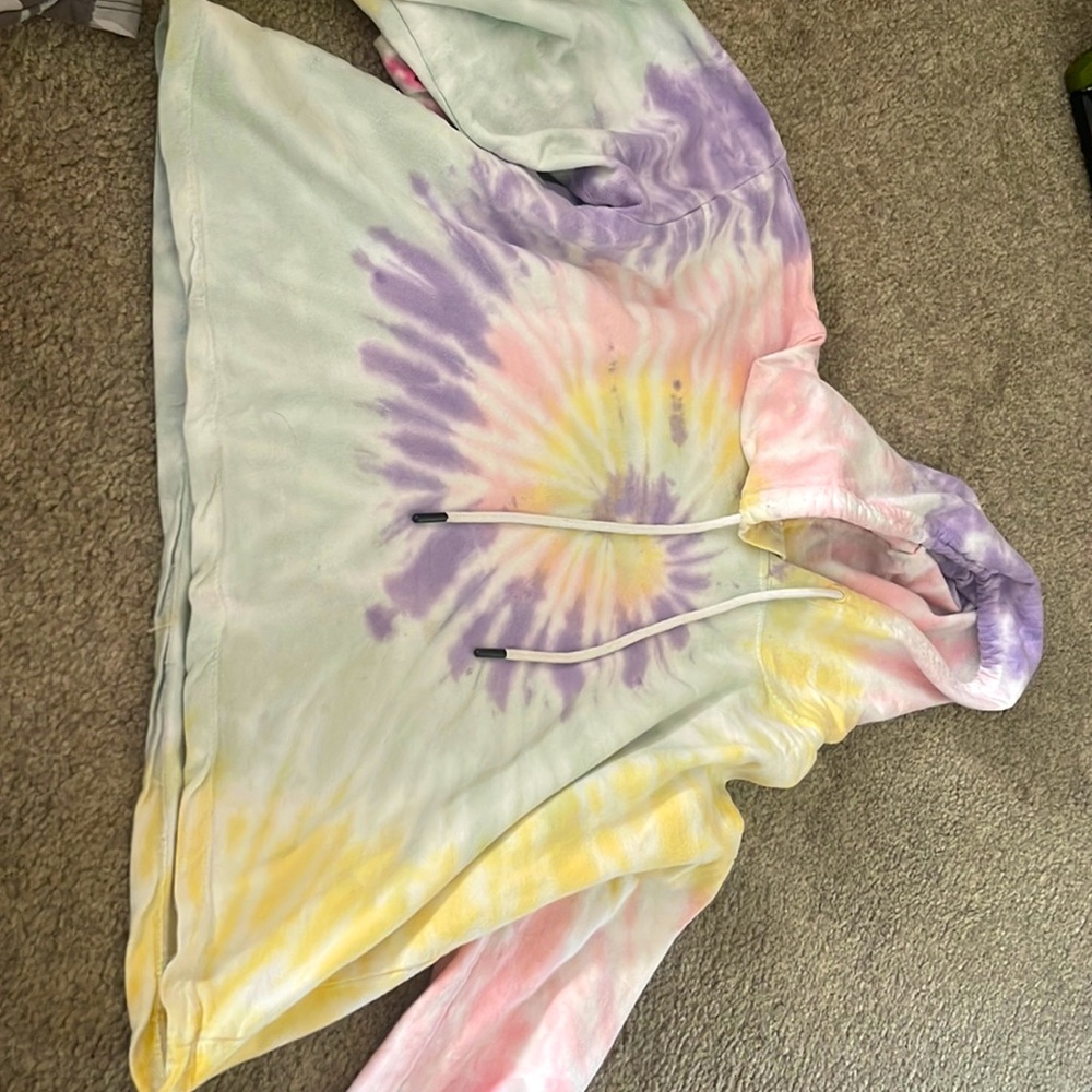 It is a crop top hoodie and it is tie dye with purple blue yellow and pink